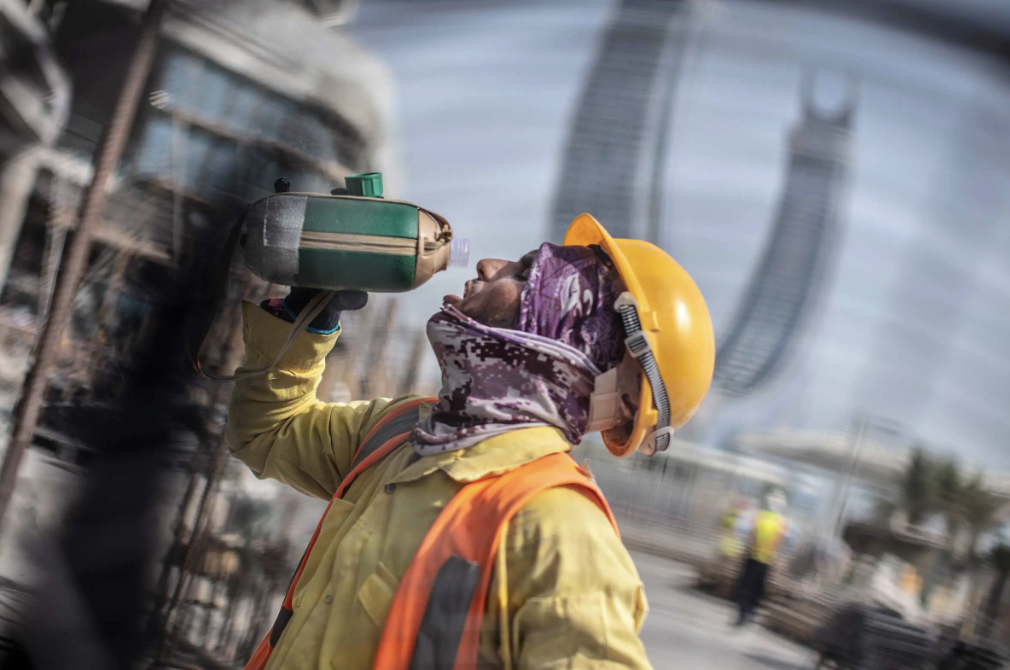 Photo of migrant worker drinking water during construction ahead of the Qatar World Cup